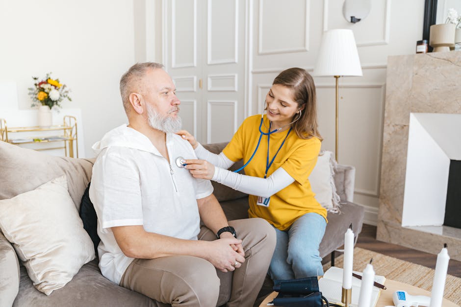 Nurse using stethoscope for home checkup on senior patient