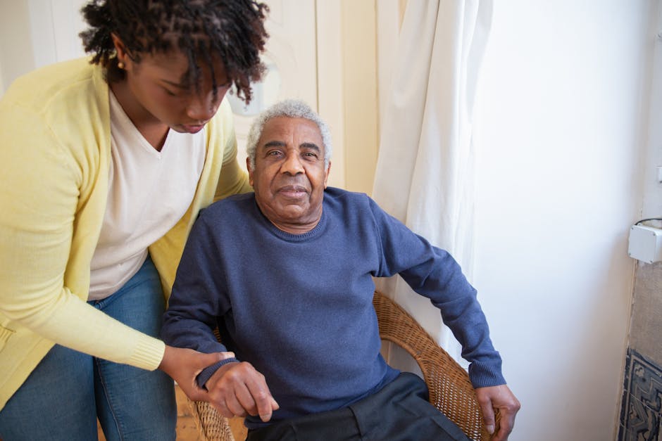 Caregiver assisting elderly woman at home